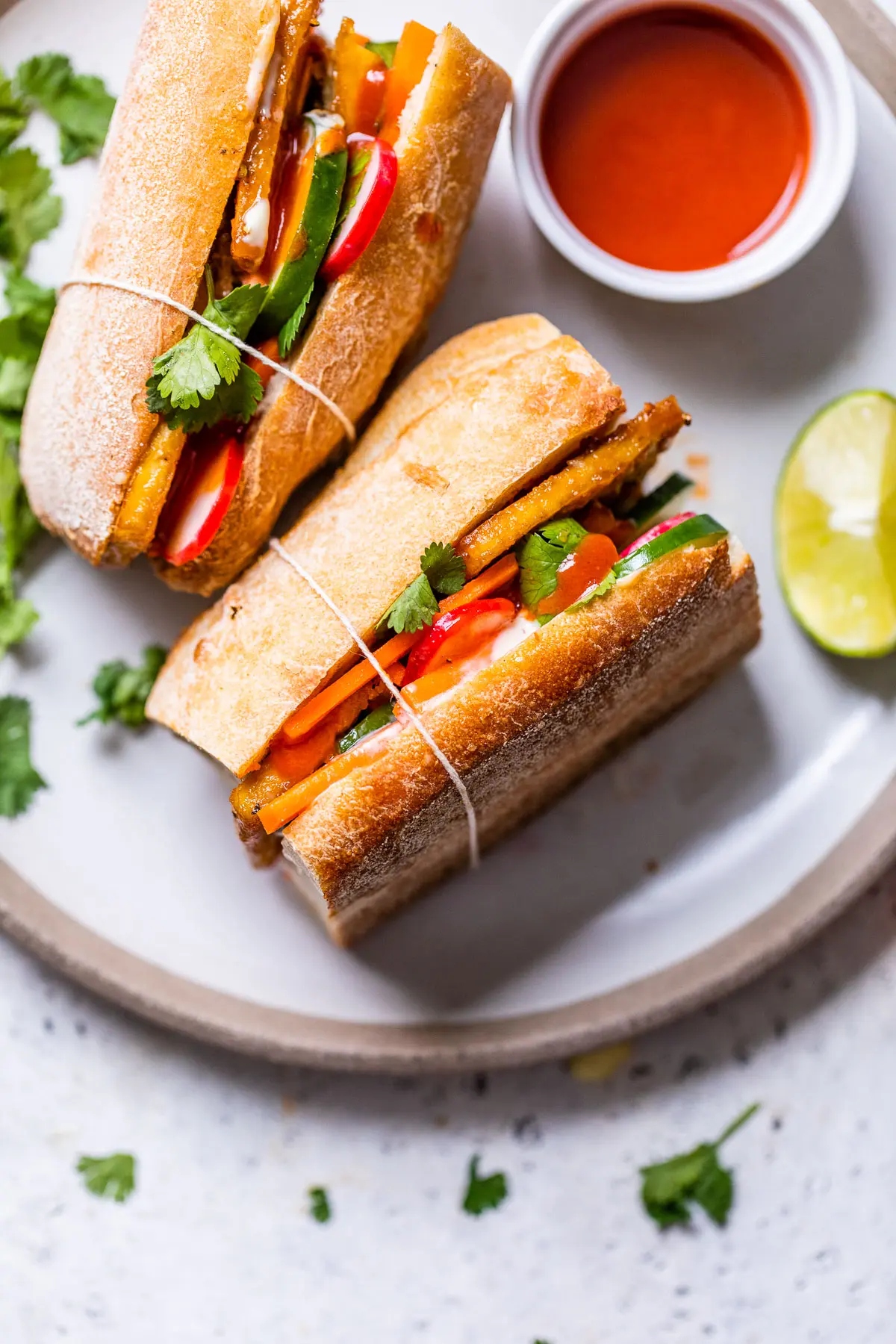 Two cuts of tofu banh mi sandwich.