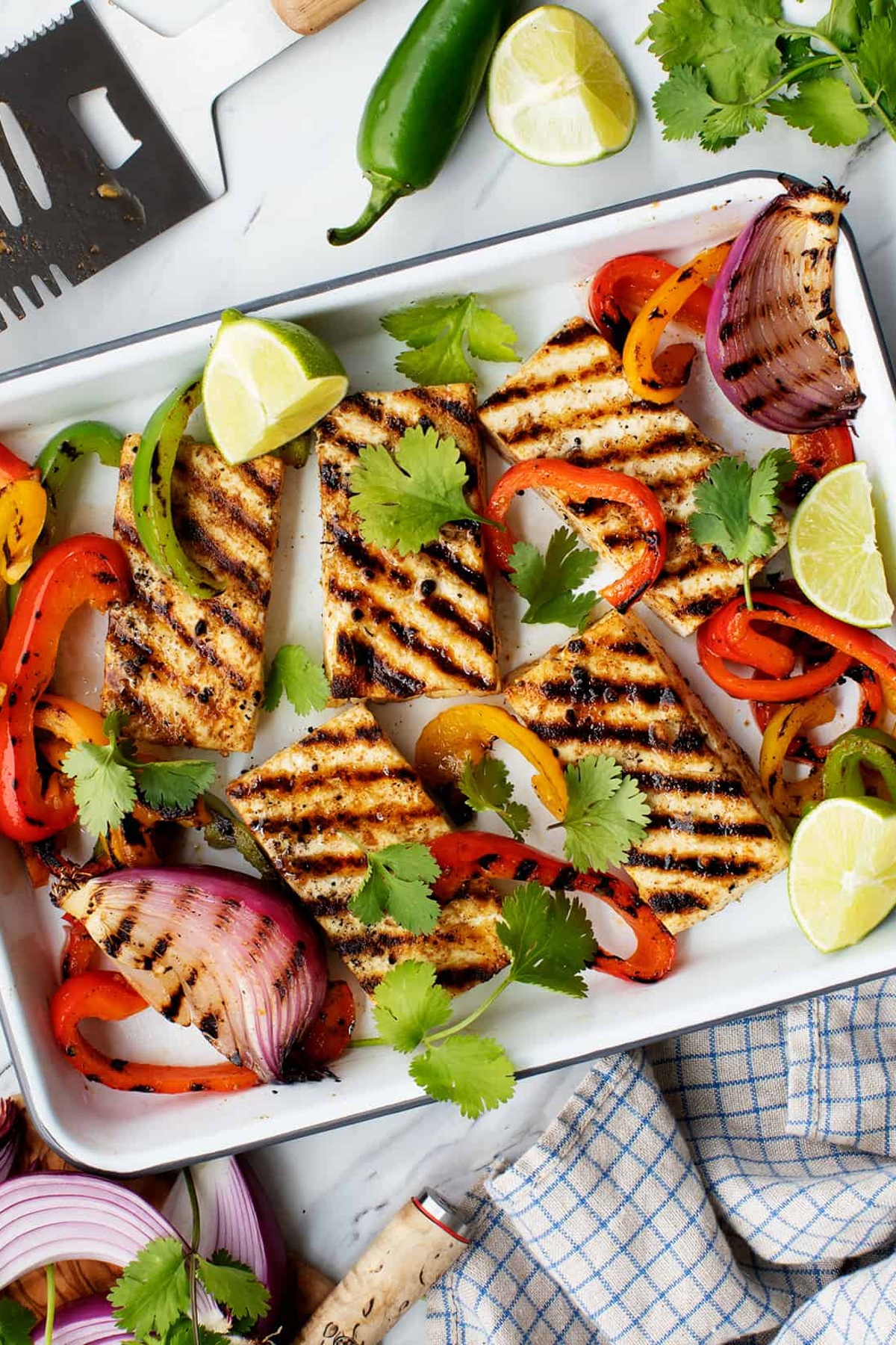 Grilled tofu with grilled spices in a rectangular pan.