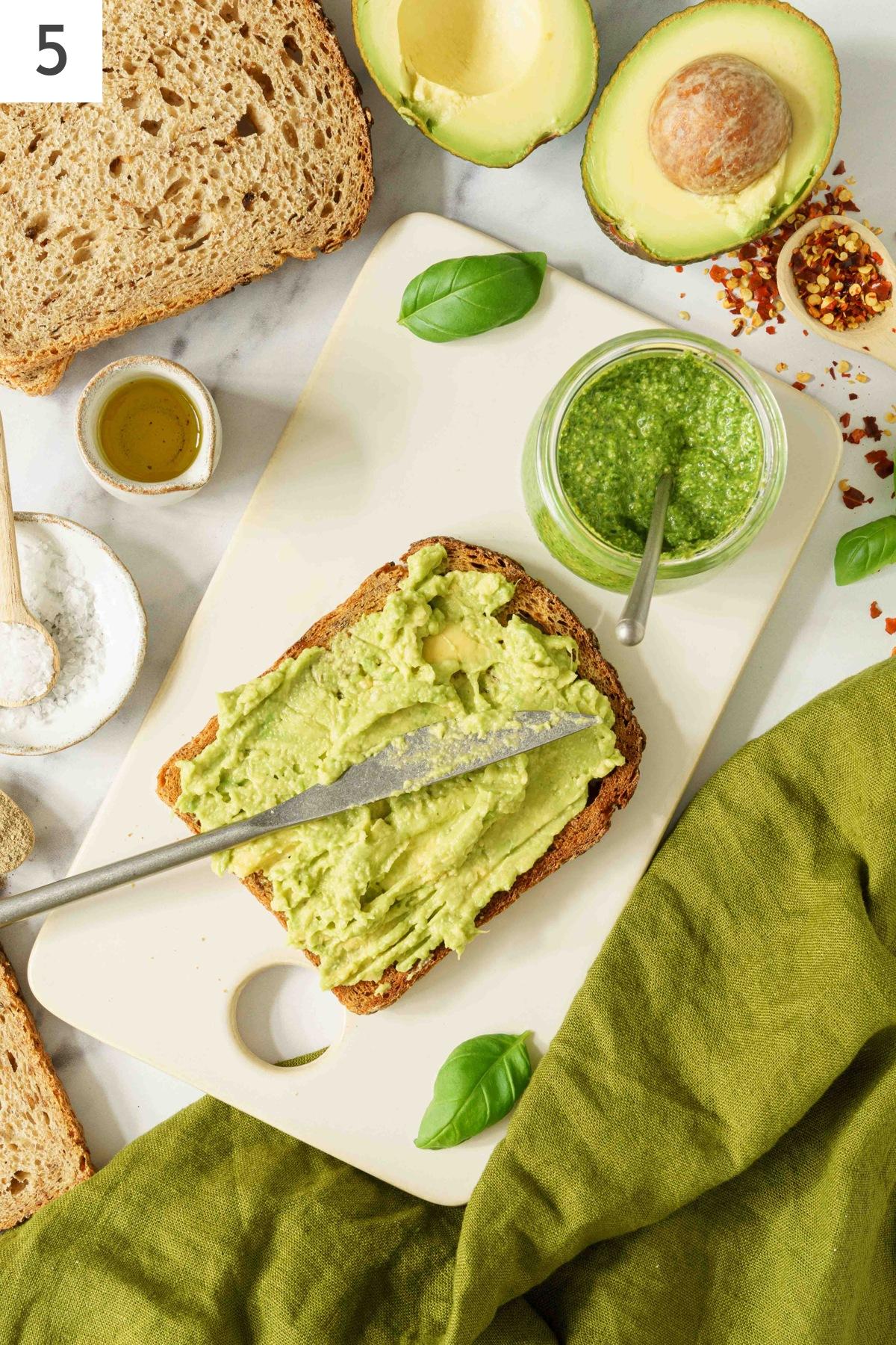 A slice of bread spread with mashed avocado.