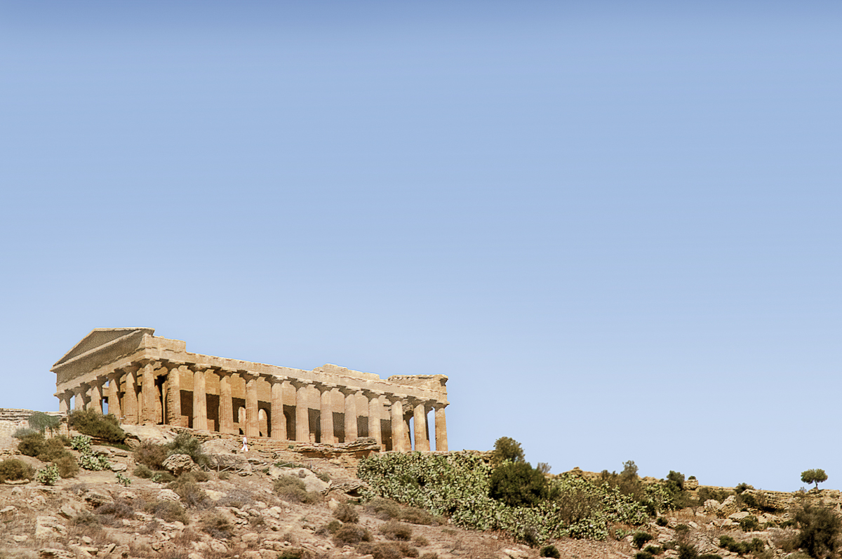 A view of a Greek temple in Agrigento against the blue sky.