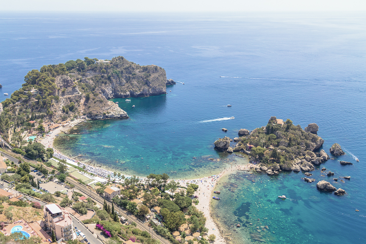 Aerial view of island and Isola Bella beach and blue ocean water in Taormina.