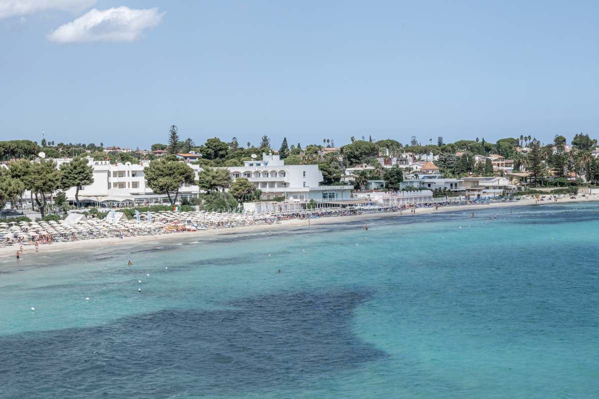Landscape of a beautiful beach with clear and crystalline turquoise water and fine sand in Sicily in Syracuse called Fontane Bianche.