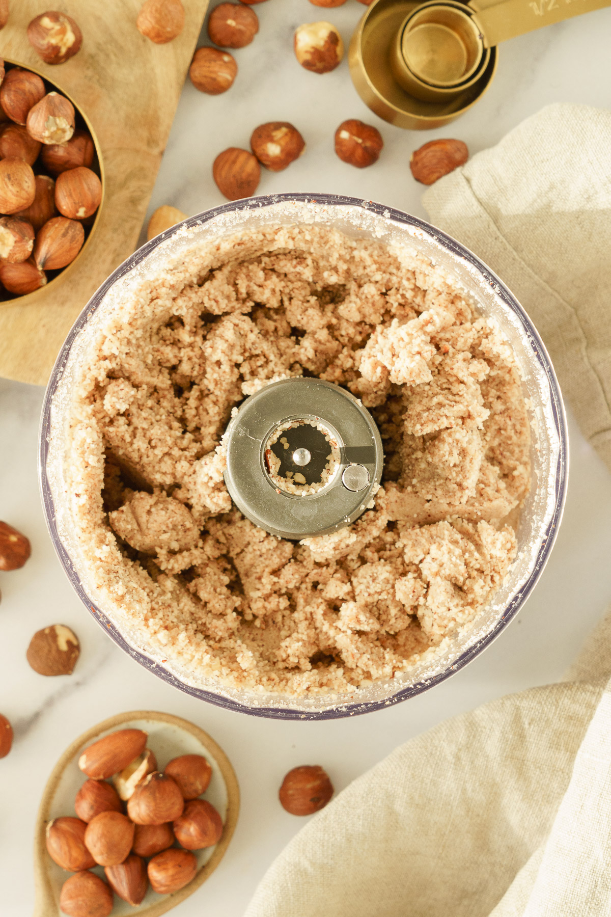 Clumped hazelnuts in a food processor.