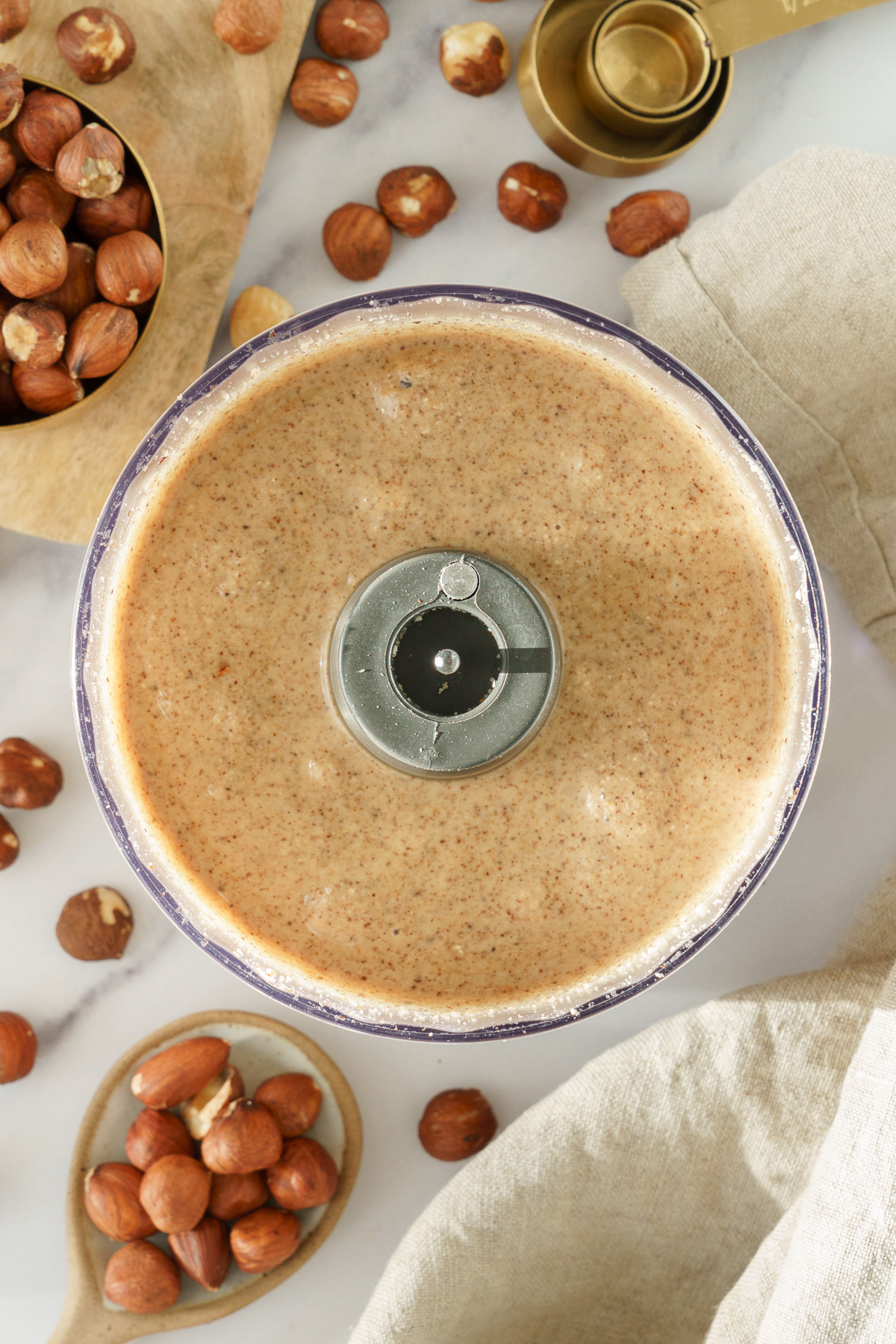 Smooth hazelnuts in a food processor.