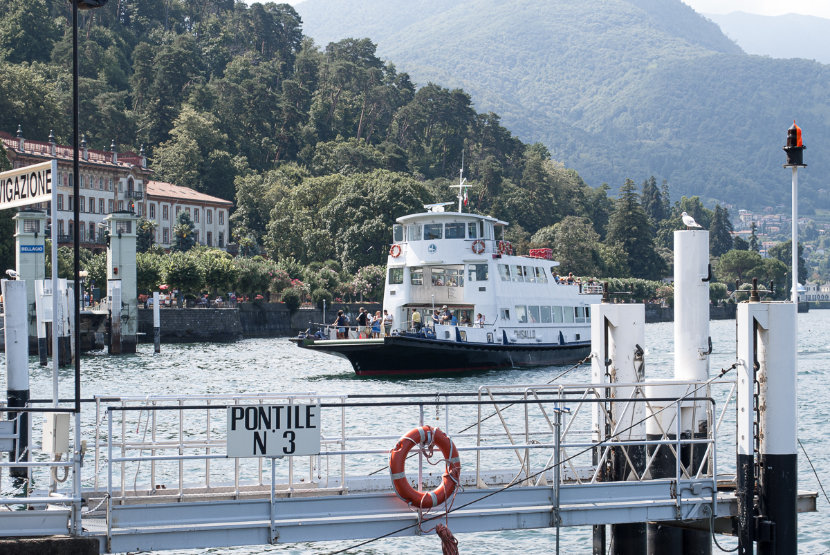 A ferry reaching shore on lake Como.