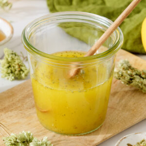A small jar filled with Mediterranean Salad Dressing.