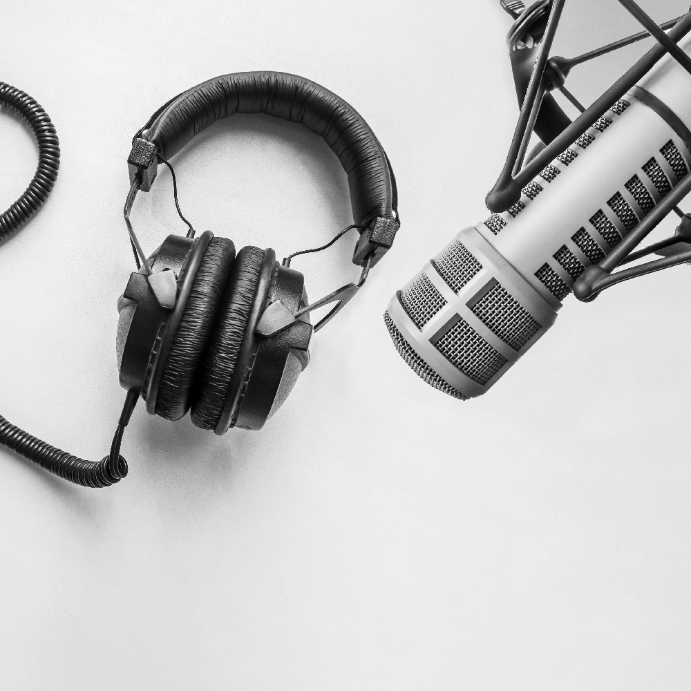 Headphones and professional microphone on white background.