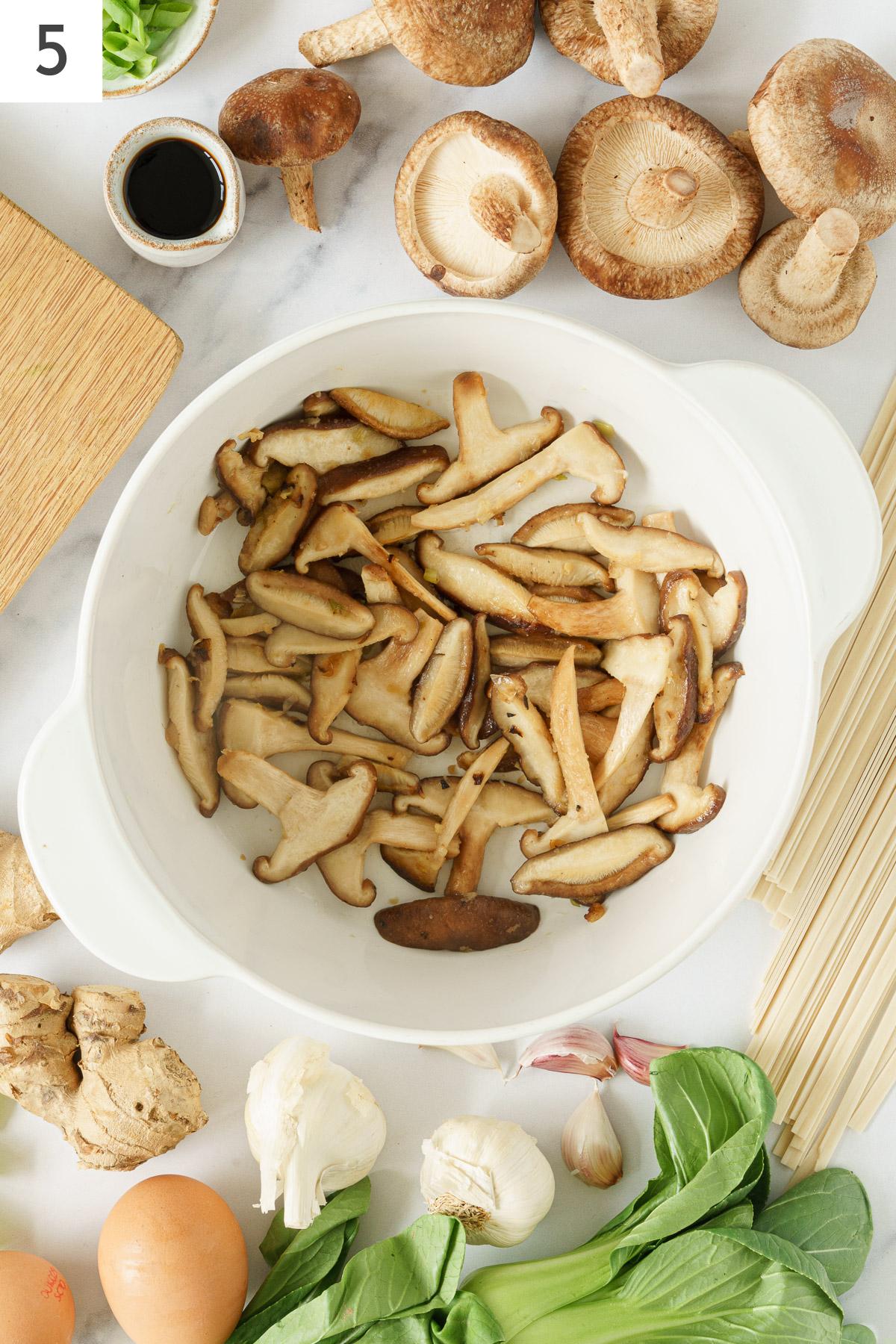 Cooked shitake mushrooms in a pot.