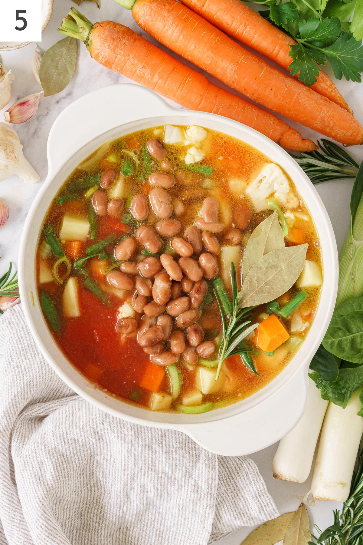 Simmered Italian minestrone soup ingredients with added beans.
