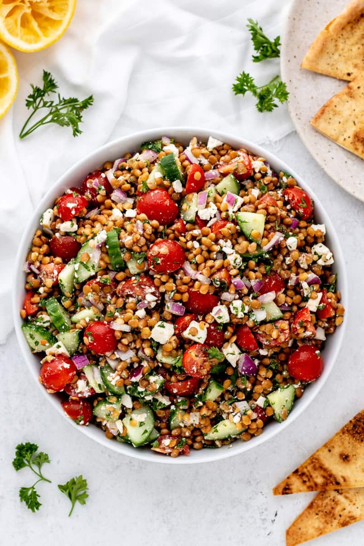 A bowl of mediterranean lentil salad.