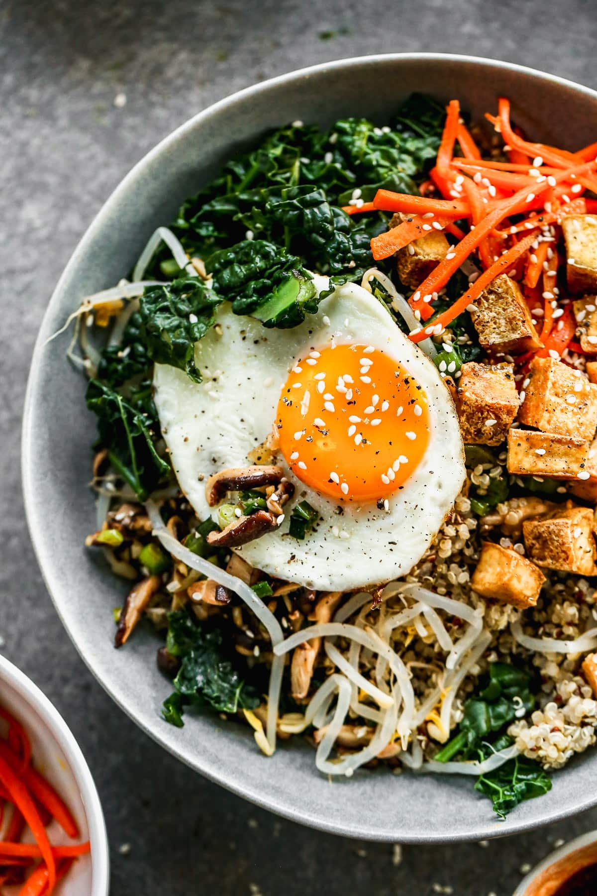Vegetarian bibimbap on a plate topped with egg.