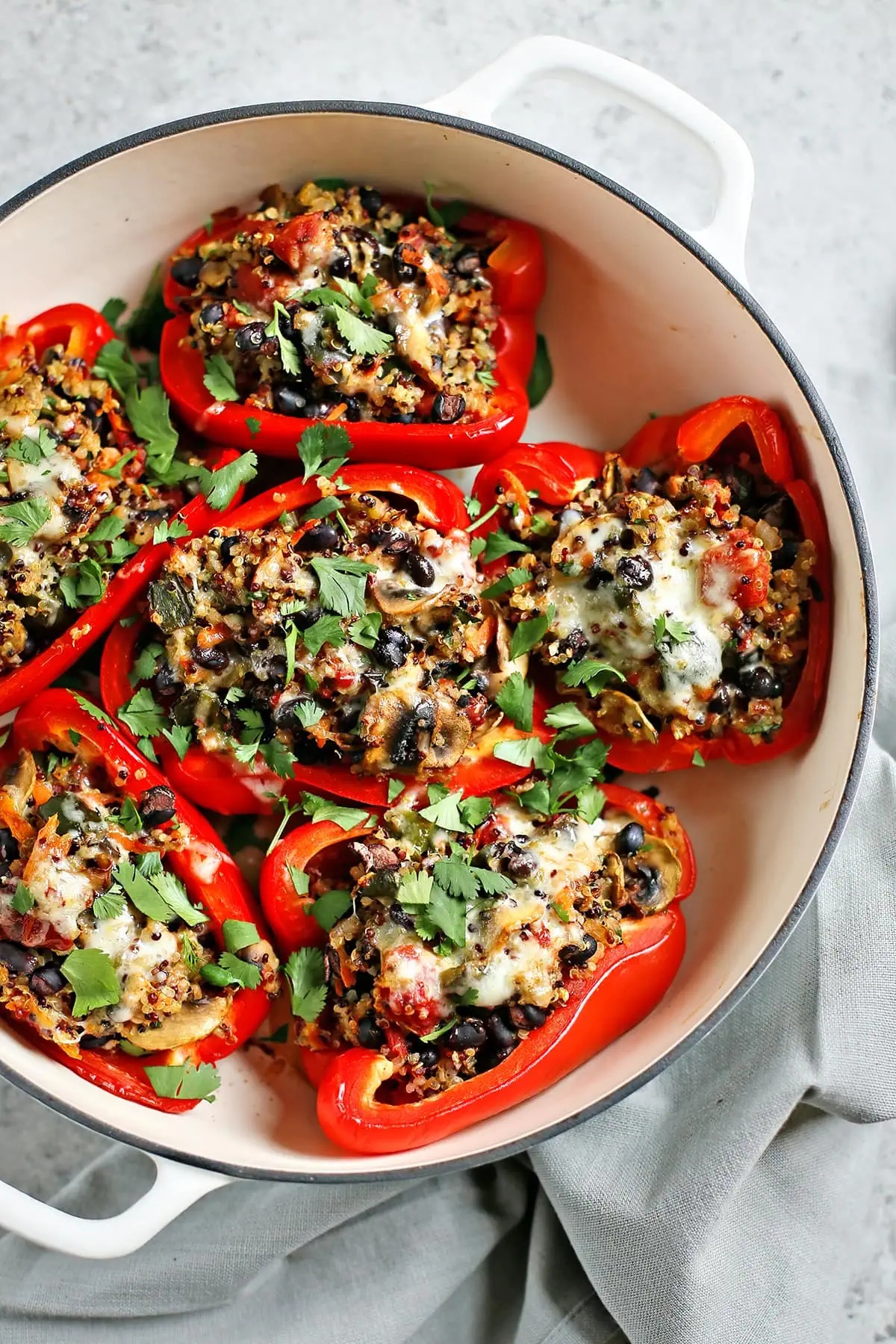 Quinoa stuffed bell peppers in a cooking pot.