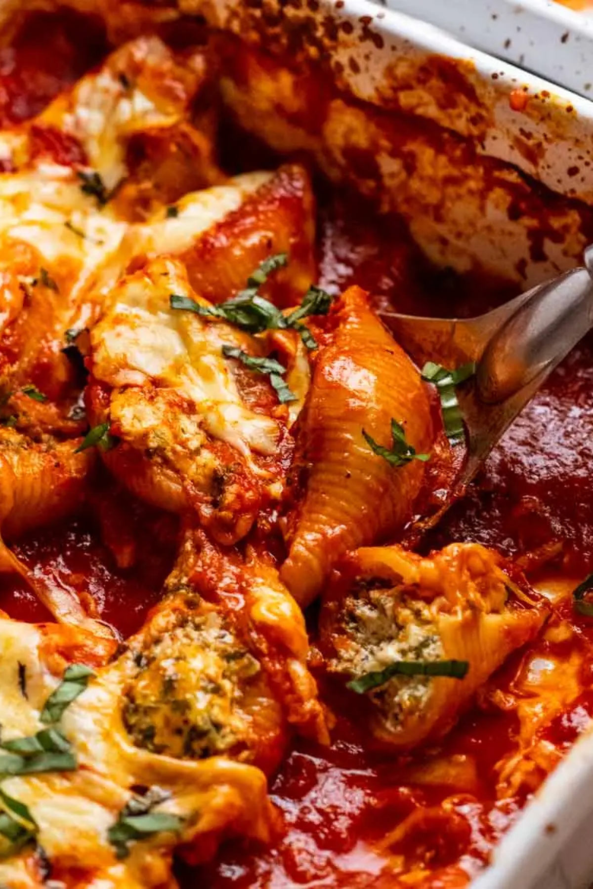 Spinach ricotta stuffed shells in a rectangular dish.