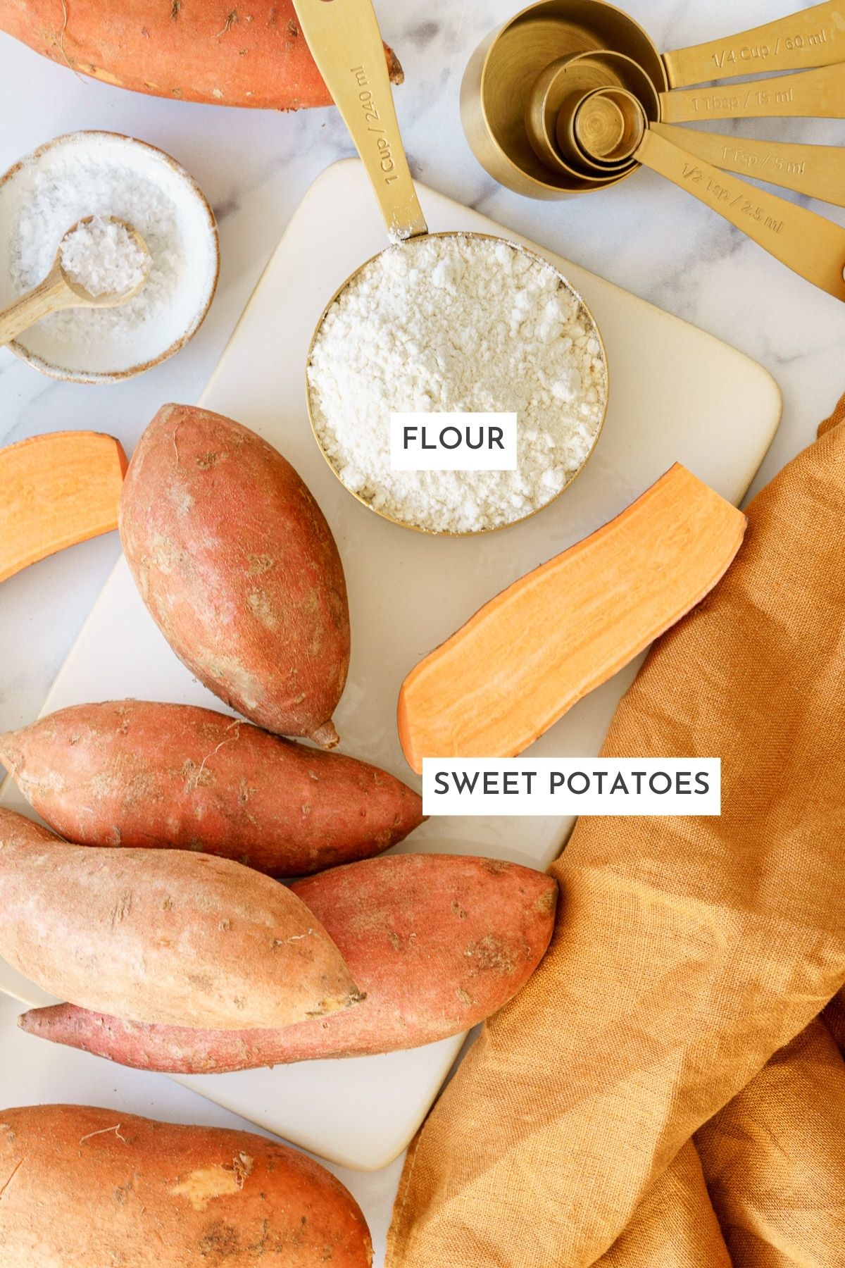 Laid out ingredients of sweet potato gnocchi: flour, and sweet potatoes.