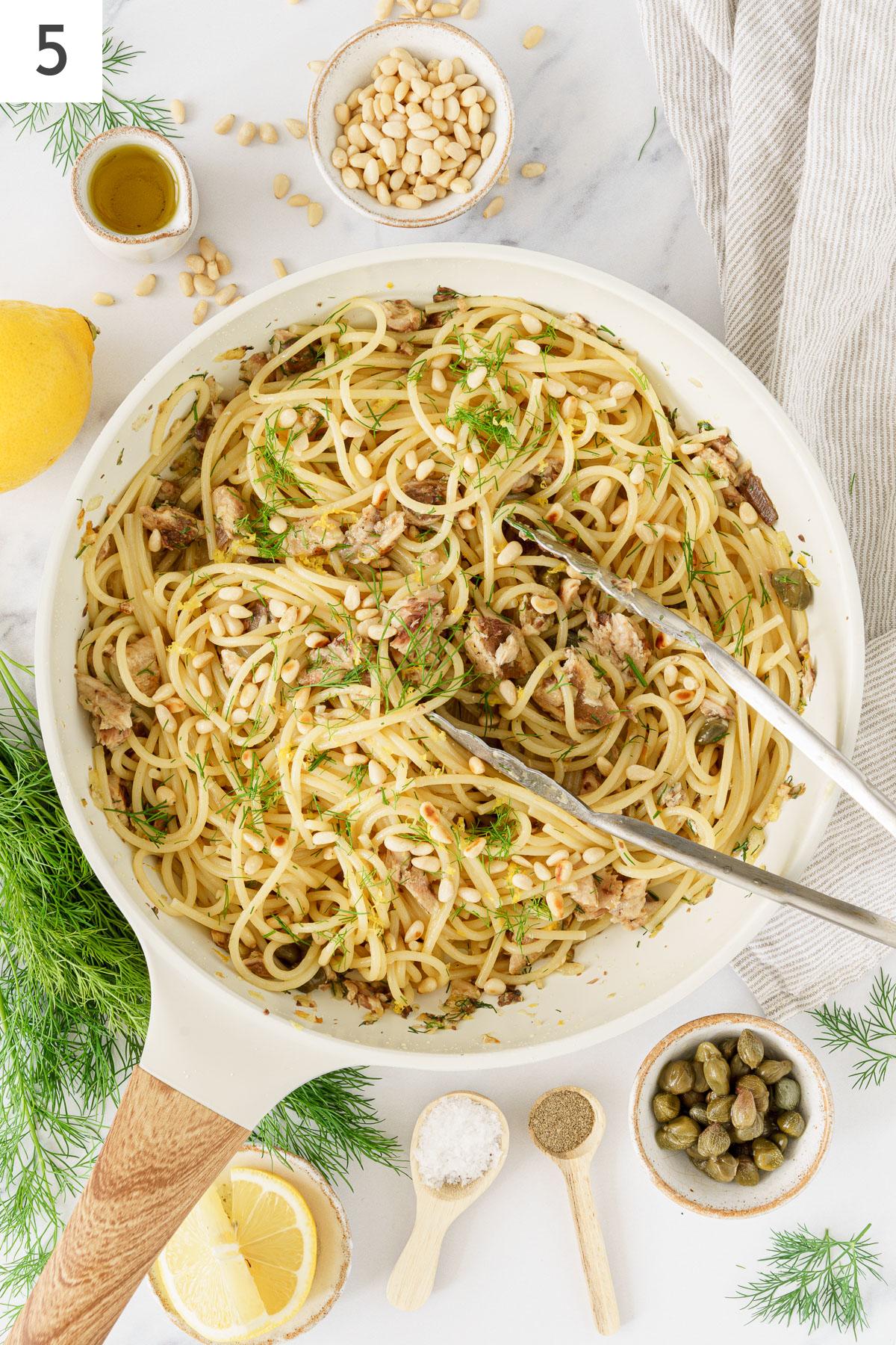 Add the cooked pasta into thee skillet with sardines and sauteed ingredients.