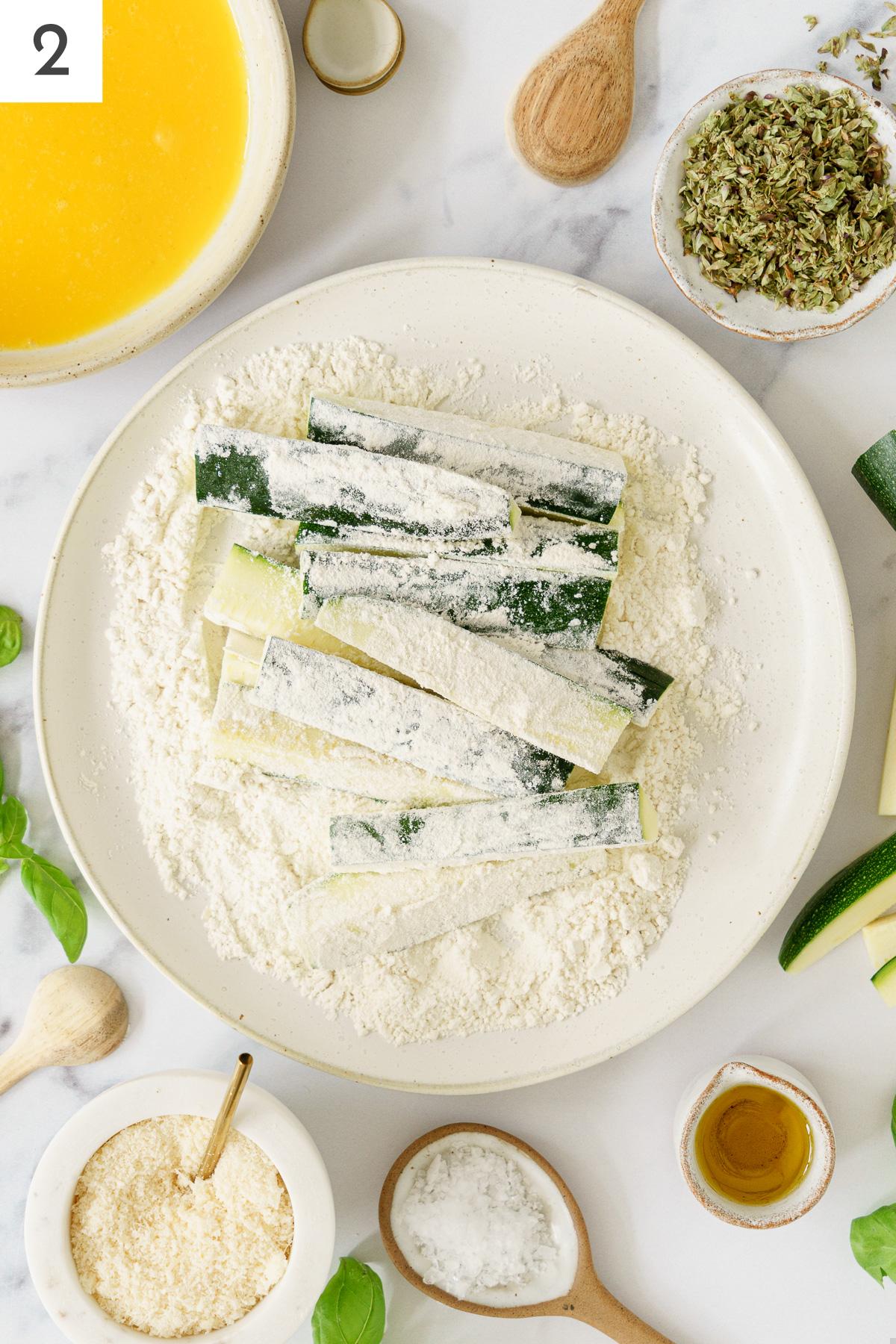 Zucchini sticks coat in flour.