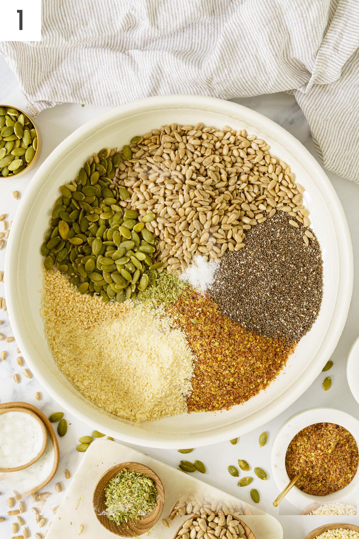 A bowl with the combined ingredients of seed crackers.