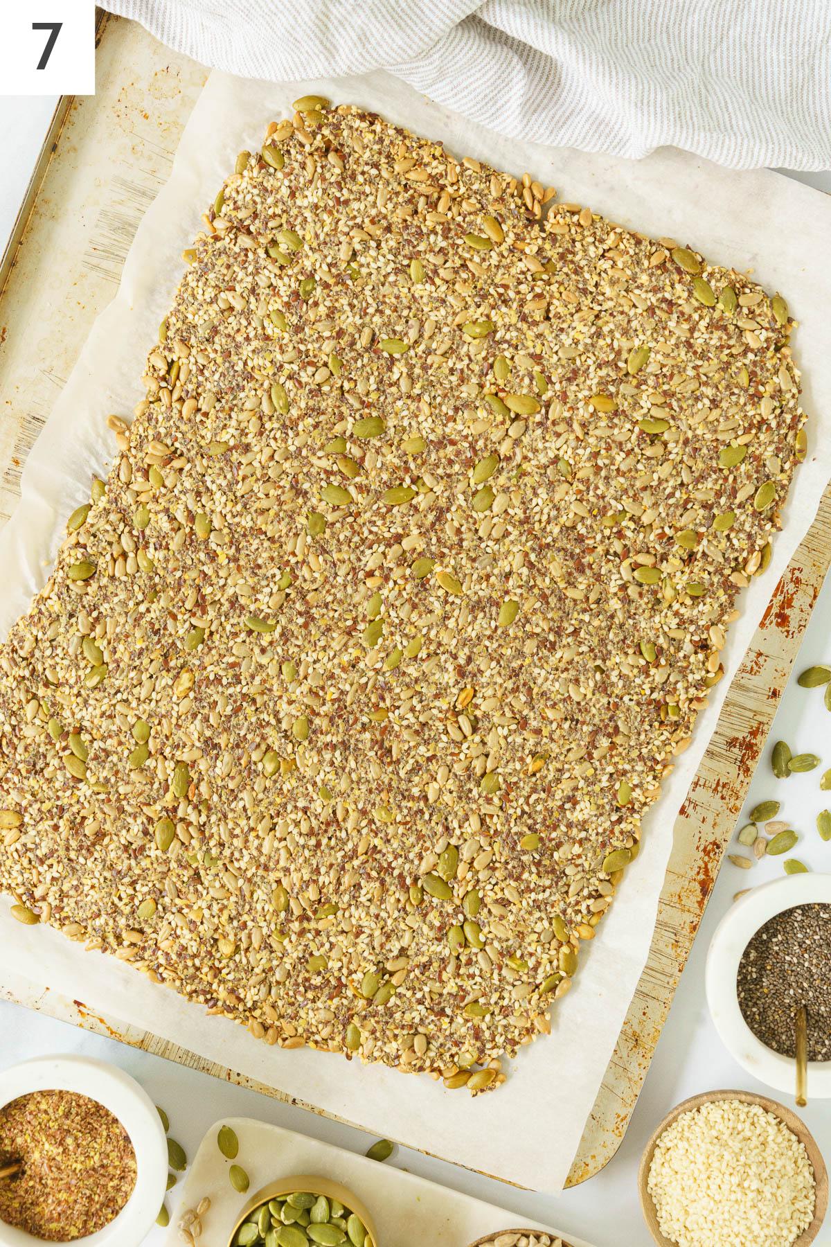 Flaten dough like mixture on a baking sheet ready to bake.