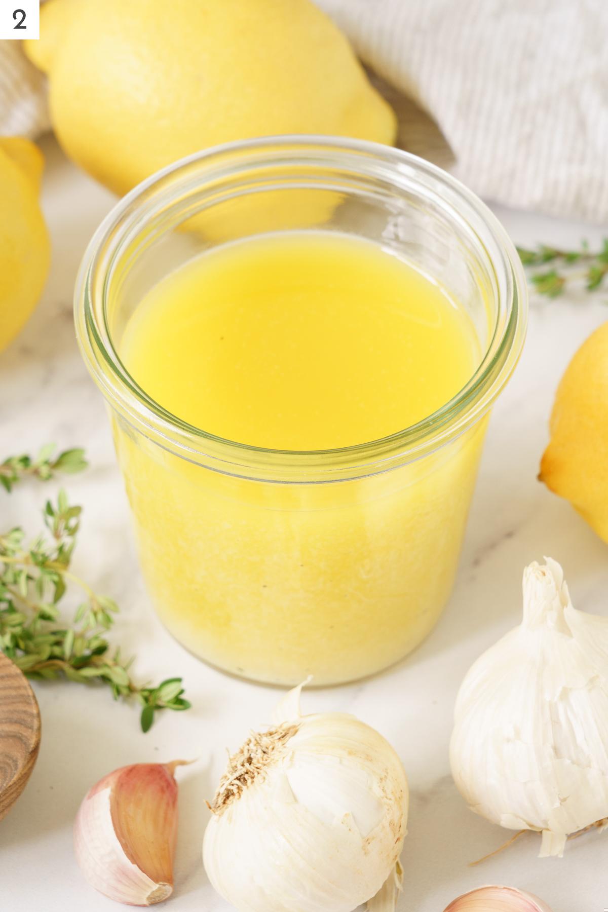 A glass container of lemon vinaigrette.